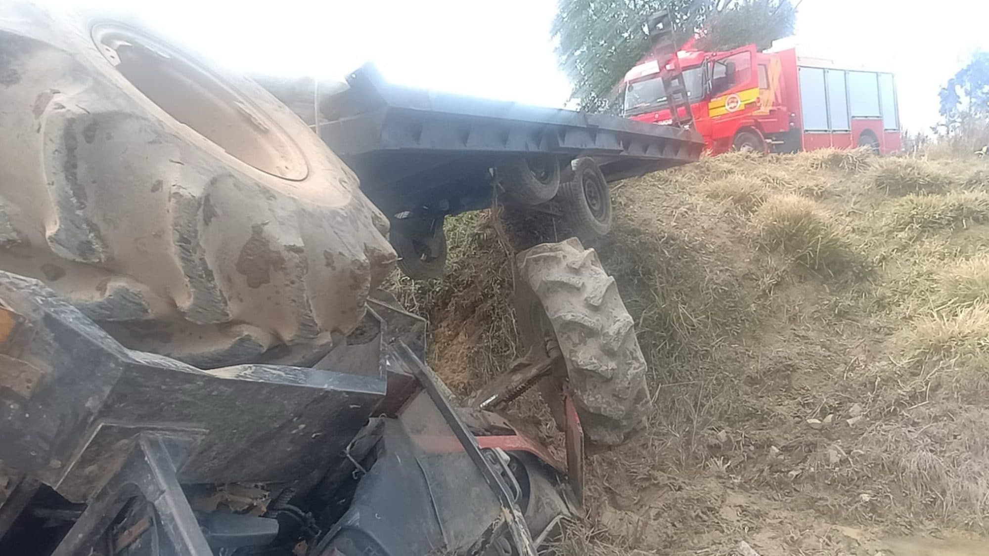 Homem morre esmagado após trator carregado de mourões capotar em estrada rural