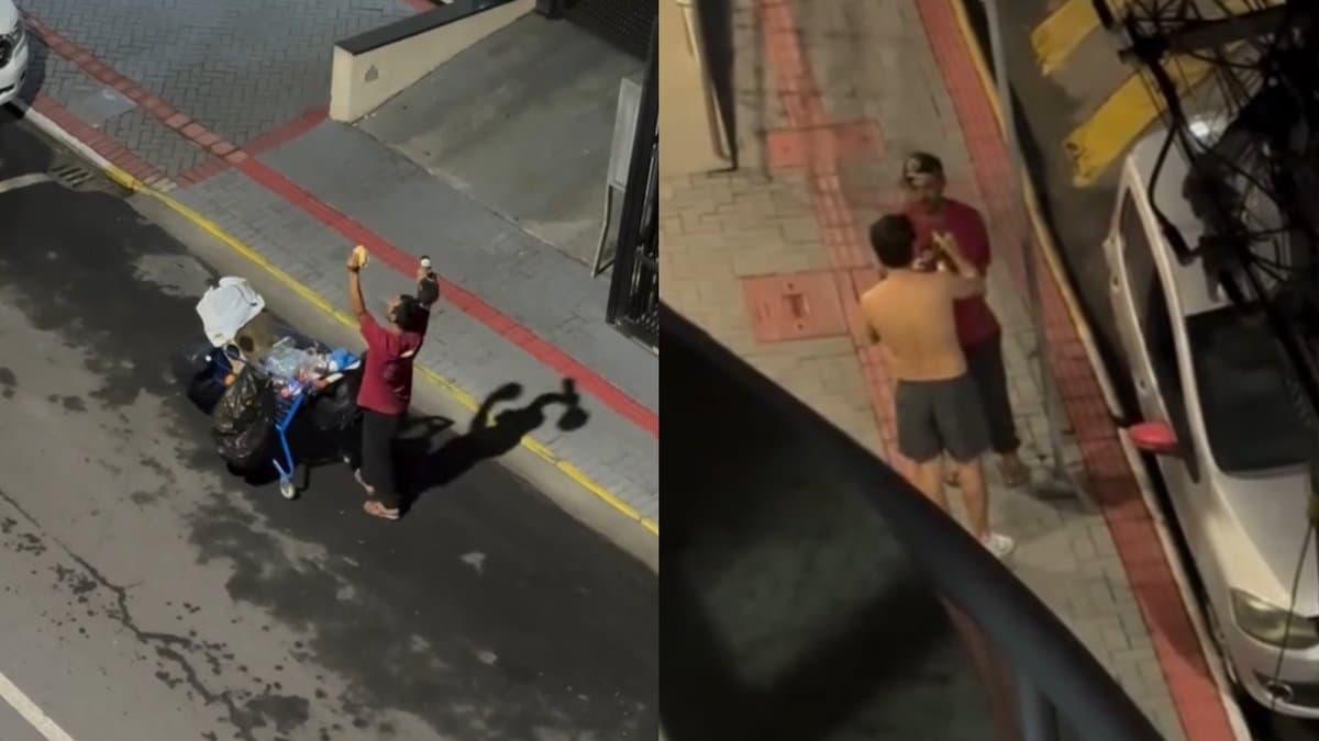 Morador de rua ergue os braços para o céu na calçada em Meia Praia, em Itapema, após receber pão com carne de morador de prédio